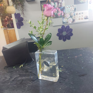 Rectangular bud vase with a rose.